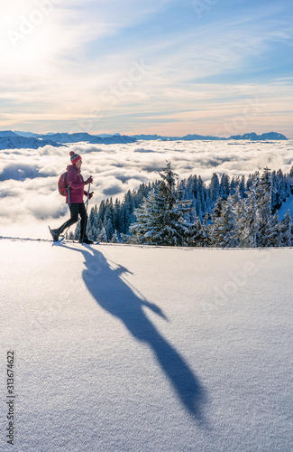 nice senior woman snowshoei...