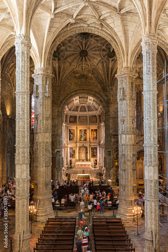 Fototapeta Naklejka Na Ścianę i Meble -  People at the main chapel of the Church of Santa Maria at Mosteiro dos Jeronimos (Jeronimos Monastery) in Belem, Lisbon, Portugal.