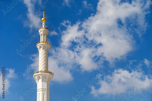 Minaret of the mosque against blue skies in Abu Dhabi, UAE 