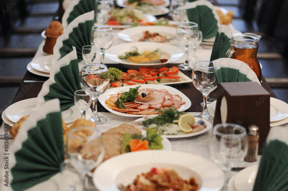 Catering table set service with silverware and glass stemware at restaurant before party