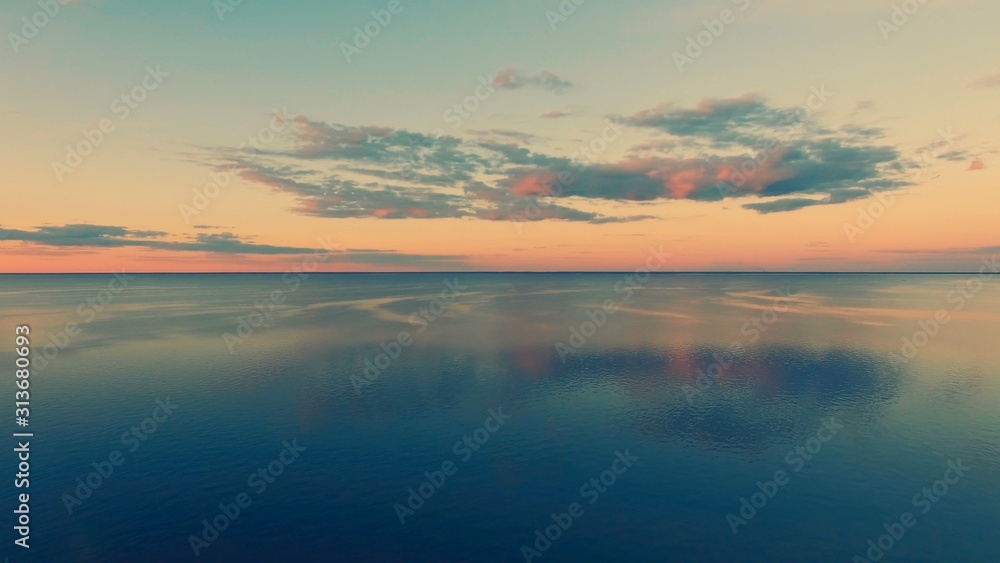 Aerial Drone Flight shooting of Beautiful Sky and Water in sunset soft light. Turn right. Magestic landscape. Kiev Sea, Ukraine, Europe.