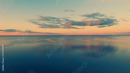 Aerial Drone Flight shooting of Beautiful Sky and Water in sunset soft light. Turn right. Magestic landscape. Kiev Sea, Ukraine, Europe.