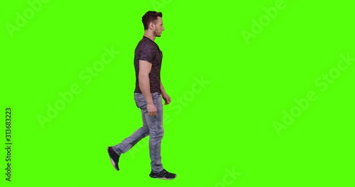 Man walking and looking around the street, waving and reacting to pedestrians and to the camera, over green screen.