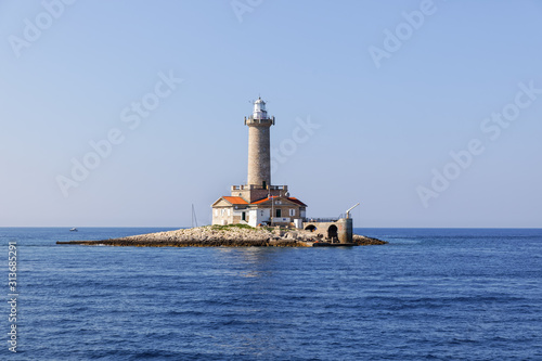 old stone lighthouse on small island