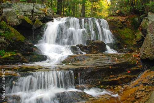 New England waterfall. Cascading waterfall in the forest during autumn season