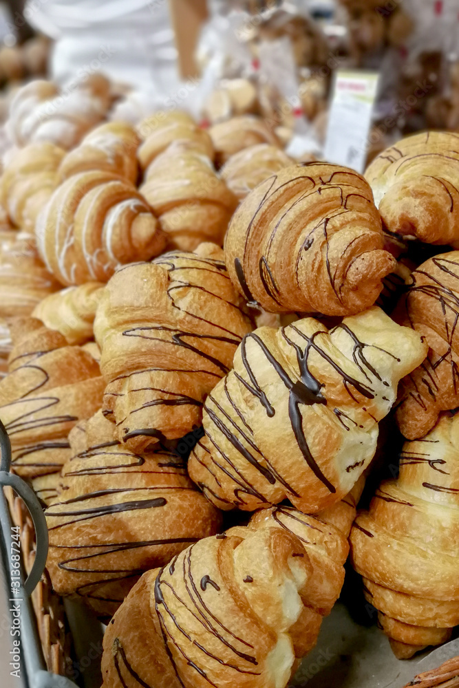 Lots of traditional croissants on the counter. Classic breakfast. Treats for guests and participants of the event. Catering and food in a restaurant, hotel or cafe