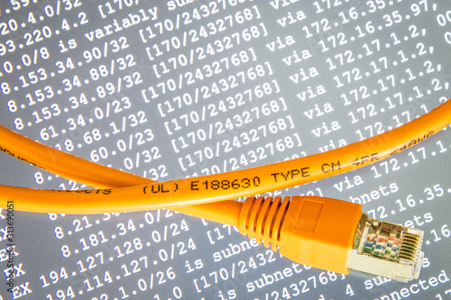 Orange internet cable on gray background with ip addresses