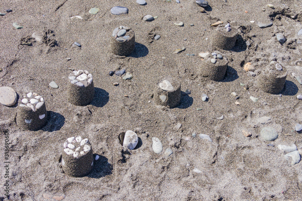 many sand cakes on the beach. Kids having fun on vacation many sand cakes on the beach. Kids having fun on vacation