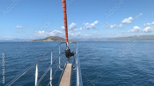 View from the fore of the pleasure boat in open sea with many islands. Summer vacation. Ocean view. Mountains. 4k video