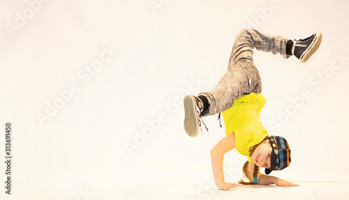 a little girl performs breakdance, a child in a unique acrobatic dance pose,bgirl in action