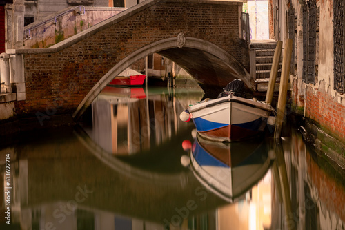 docked boat on a picturesque water canal in Venice italy