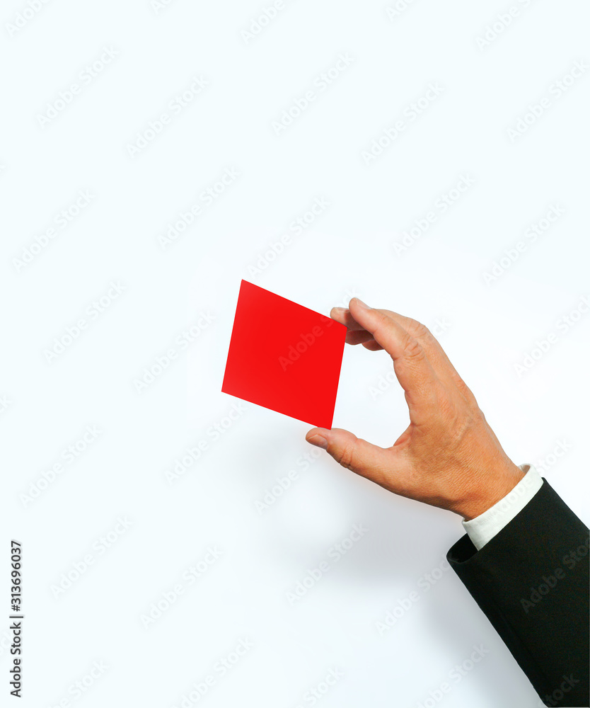 concept image of a businessman's hand in a gesturing pose - holding/showing a red color card