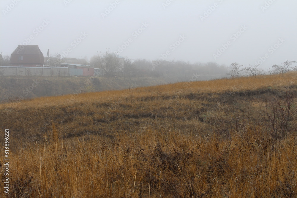 Fototapeta premium Beautiful rural landscape on the horizon against the background of hills