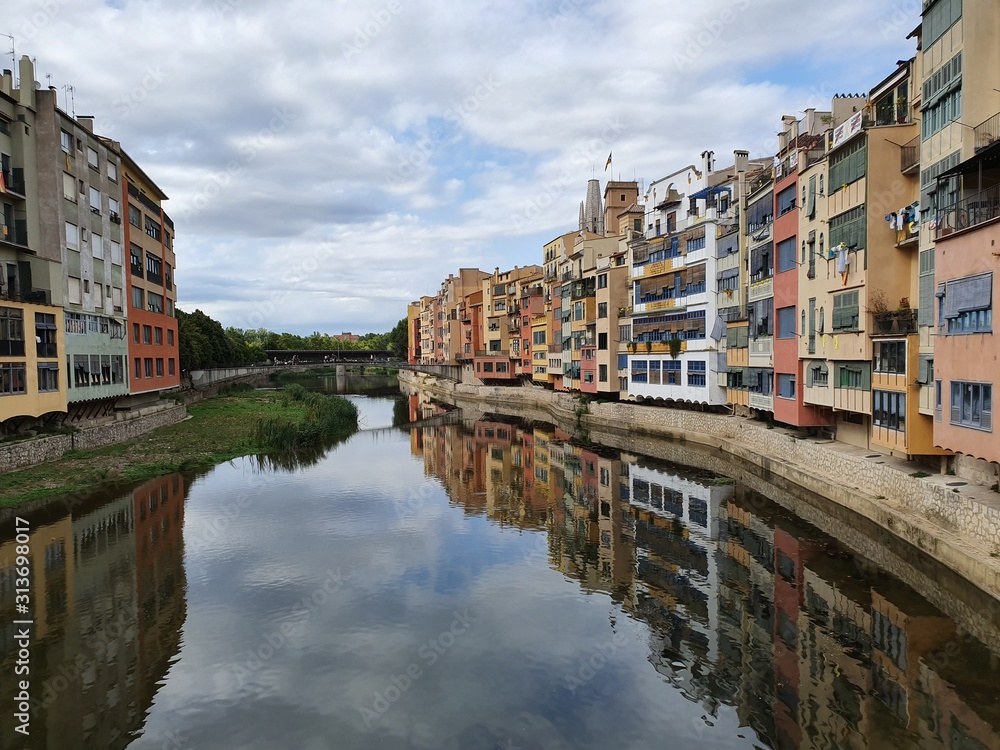 The city on the river, bridge and street of the old town with colofrul houses in summer  Spain.