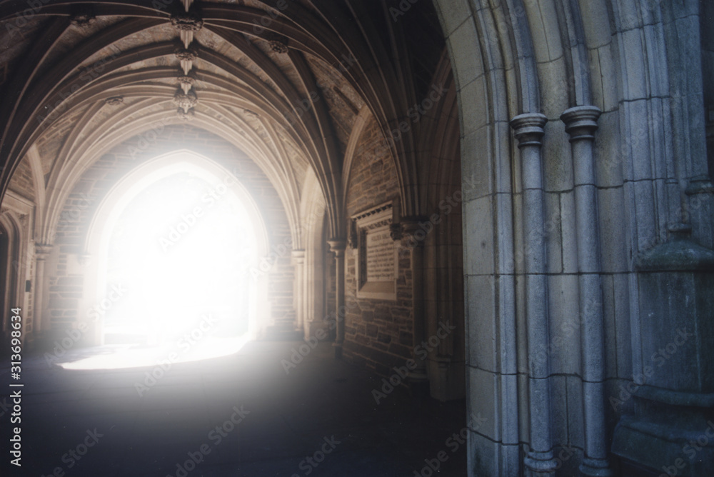 Gothic archway with light illuminating the path