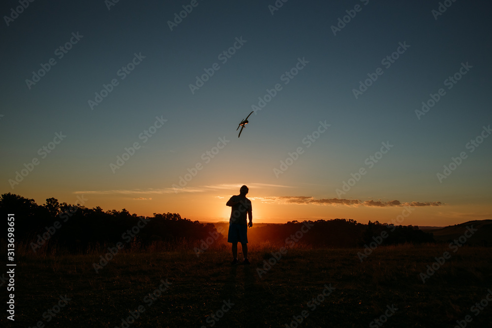 man with airplane at sunset