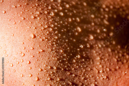 Full frame background of water drops collected on smooth skin
