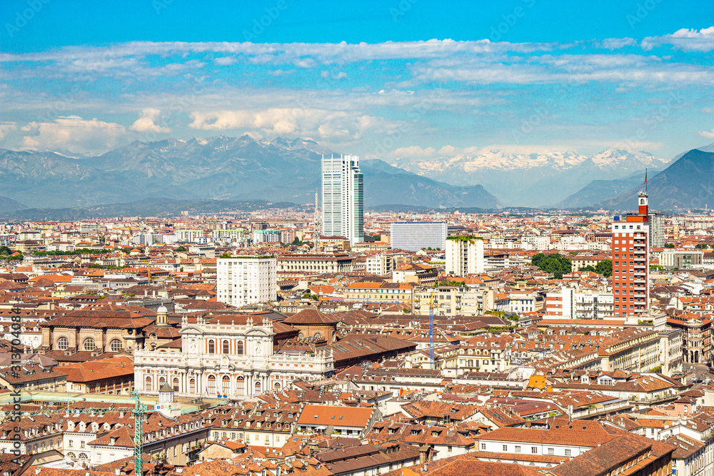 Fototapeta premium Aerial PAnoramic summer view on Turin skyline, with the city center, Po river, Mole Antonelliana, modern skyscrapers and other landmark seen from viewpoint the Monte dei Cappuccini on snowy alps Italy