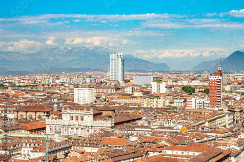 Aerial PAnoramic summer view on Turin skyline, with the city center, Po river, Mole Antonelliana, modern skyscrapers and other landmark seen from viewpoint the Monte dei Cappuccini on snowy alps Italy