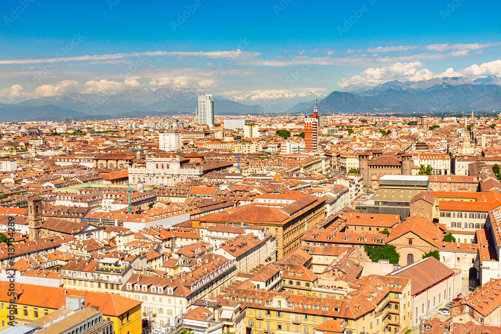 Aerial PAnoramic summer view on Turin skyline, with the city center, Po river, Mole Antonelliana, modern skyscrapers and other landmark seen from viewpoint the Monte dei Cappuccini on snowy alps Italy