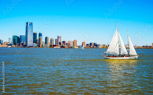 Jersey City, New Jersey and Hudson River. View from Manhattan, New York of USA. Skyline and cityscape with skyscrapers at United States of America, NYC, US. Road and American architecture.