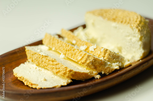 Smoked cottage cheese, brined cheese cut on a plate