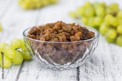 Portion of healthy Raisins (selective focus; close-up shot)