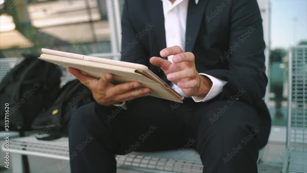 Young businessman works with tablet, checks mail, surfing the Internet, prepares a presentation Young businessman works with tablet, checks mail, surfing the Internet, prepares a presentation