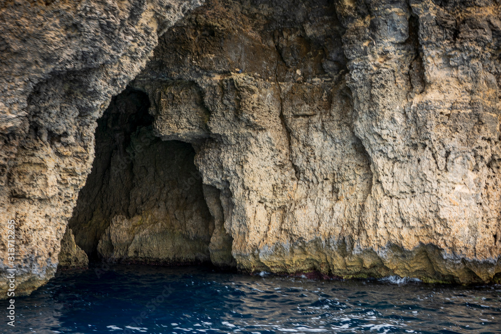 Rocky sea caves line the coasts of Malta, Gozo, Comino and the Maltese Archipelago in the Mediterranean Sea.