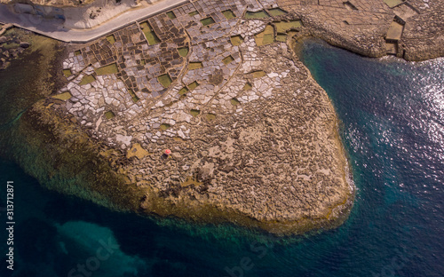 An aerial drone shot captures the salt pans on the island of Gozo in Malta. photo