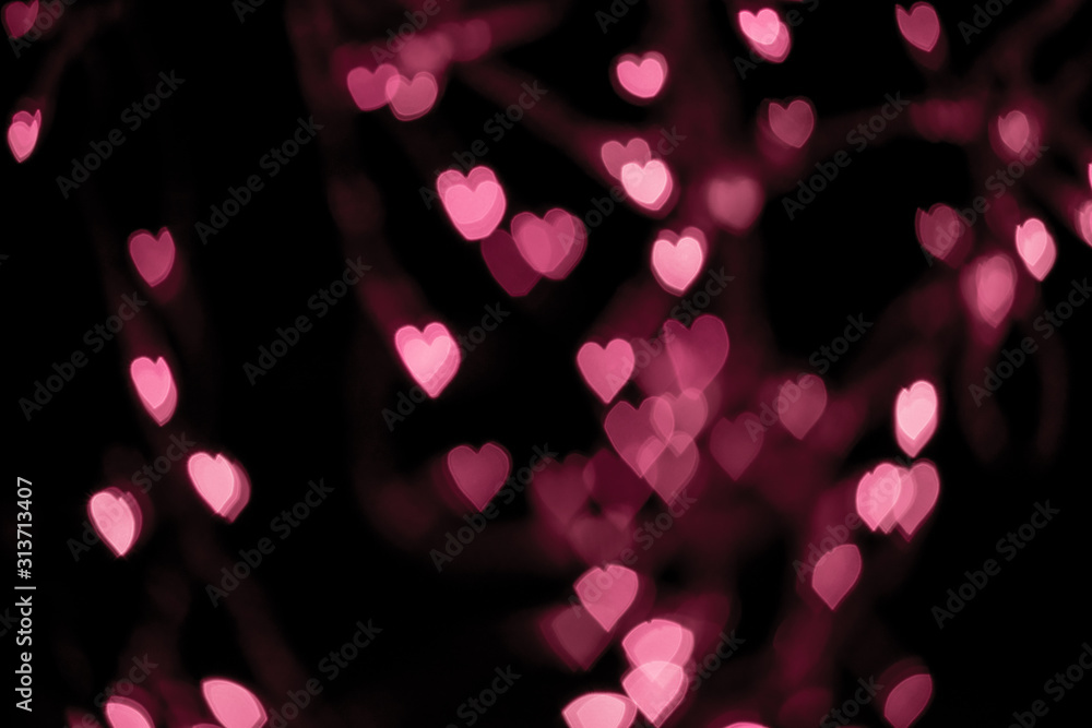 Valentines background. Abstract pink bokeh background. Defocused blurred heart shaped lights. St. Valentines Day background