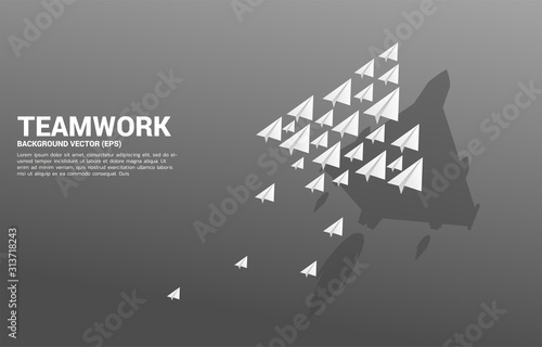 group of origami paper airplane with fighter plane shadow . Business Concept of teamwork and Collaborate