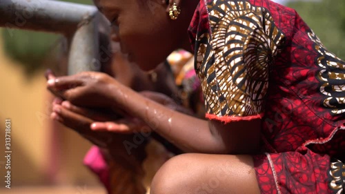 Two Funny Little African Girls Playing Around With Water At The Village Pump