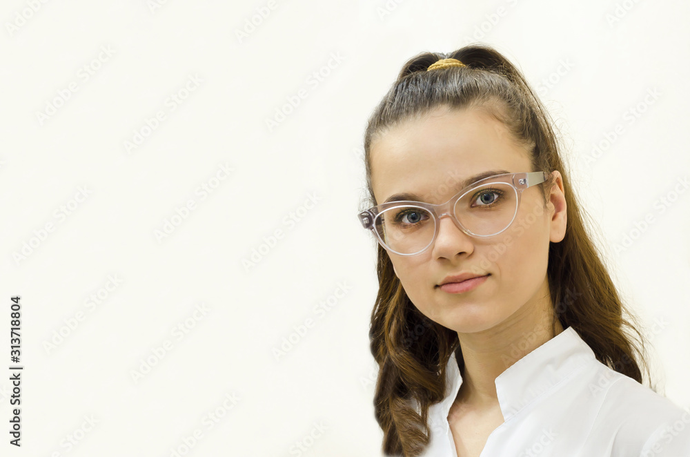 portrait young woman, girl, lady with long hair, medical student, with glasses and white coat, in uniform. doctor, nurse, medical worker looking at the camera carefully, with smile, copy space portrait young woman, girl, lady with long hair, medical student, with glasses and white coat, in uniform. doctor, nurse, medical worker looking at the camera carefully, with smile, copy space