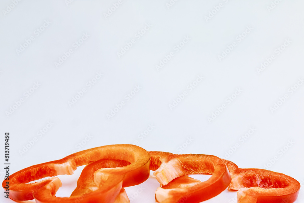 red bell pepper sliced in thin slices on a white background. red bell pepper sliced in thin slices on a white background.