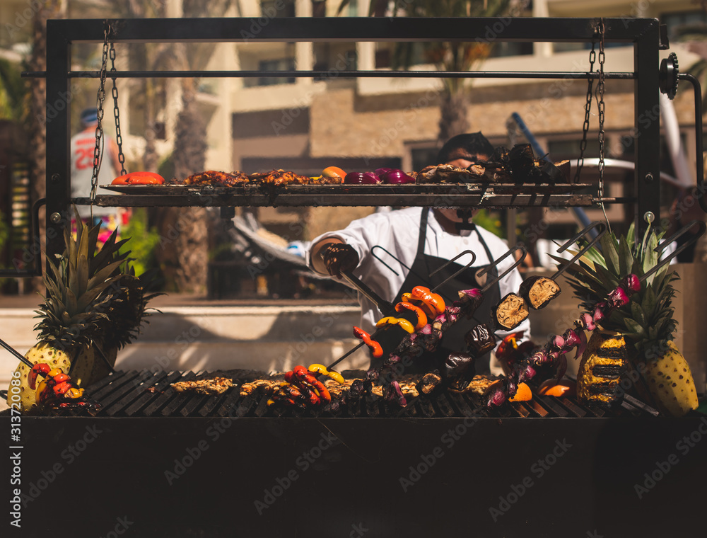Naklejka premium Los Cabos, Baja California, Mexico - Oct 2019 Barbecue is a cooking method, techniques include smoking, roasting or baking, braising and grilling