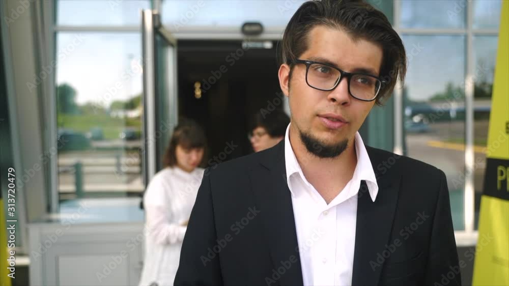 Man with glasses speaks to the camera, close angle Man with glasses speaks to the camera, close angle