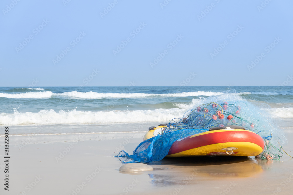 Surfboard at the beach with fishing net in Thailand