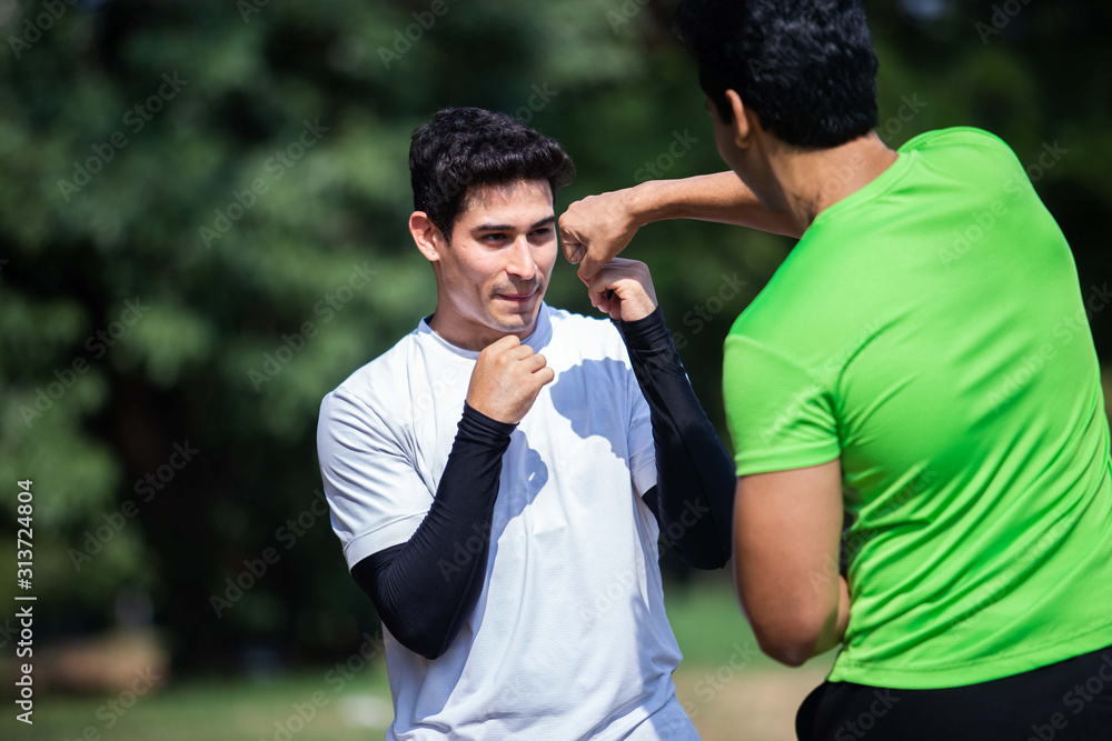 Two sport friend boxing training and fight in garden. Two sport friend boxing training and fight in garden.