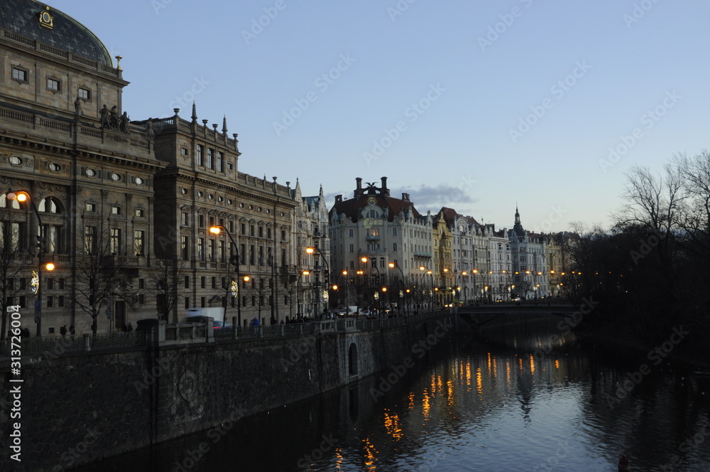 View of water and old city in Prague Czech Republic at sunset