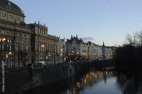View of water and old city in Prague Czech Republic at sunset