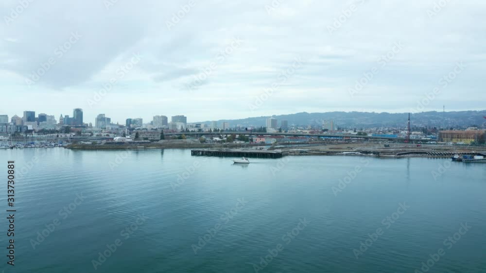 Glassy blue waters under cloudy city urban skies at day in the bay. Glassy blue waters under cloudy city urban skies at day in the bay.