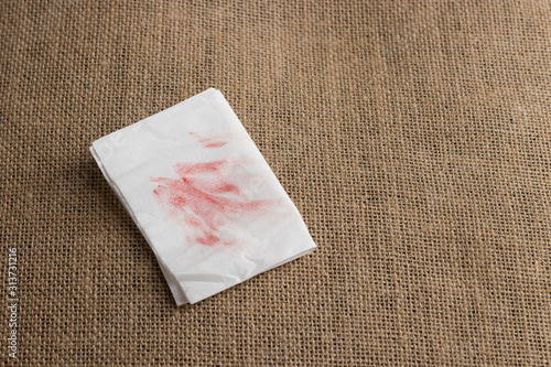 Red lipstick stain or smudges on white tissue paper