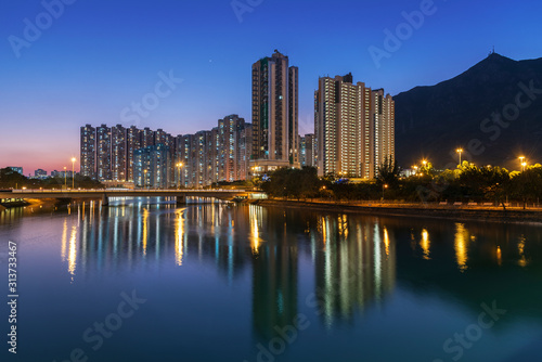 High rise residential building and mountain in Hong Kong city at dusk © leeyiutung