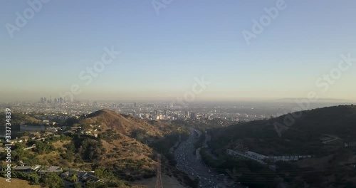 4k Drone Hollywood Hills Los Angeles mountains, blue skies, freeways, reservoir, downtown and hollywood.