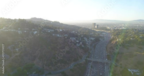 4k Drone Hollywood Hills Los Angeles mountains, blue skies, freeways, reservoir, downtown and hollywood.