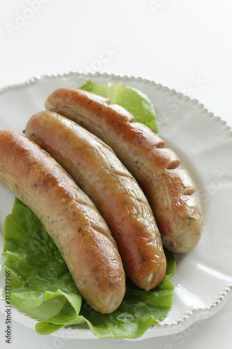 Grilled pork sausage on lettuce with copy space