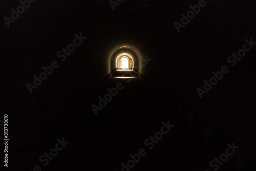 Sun-lit exit from the dark black underground passage at Fort Pospelova on the Russian island in Vladivostok.