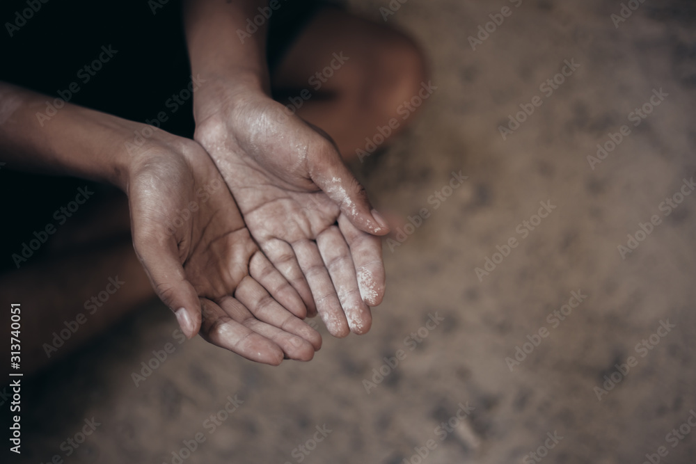 Fototapeta premium poor child or beggar begging you for help sitting at dirty slum. concept for poverty or hunger people,human rights,donate and charity for underprivileged children in third world 