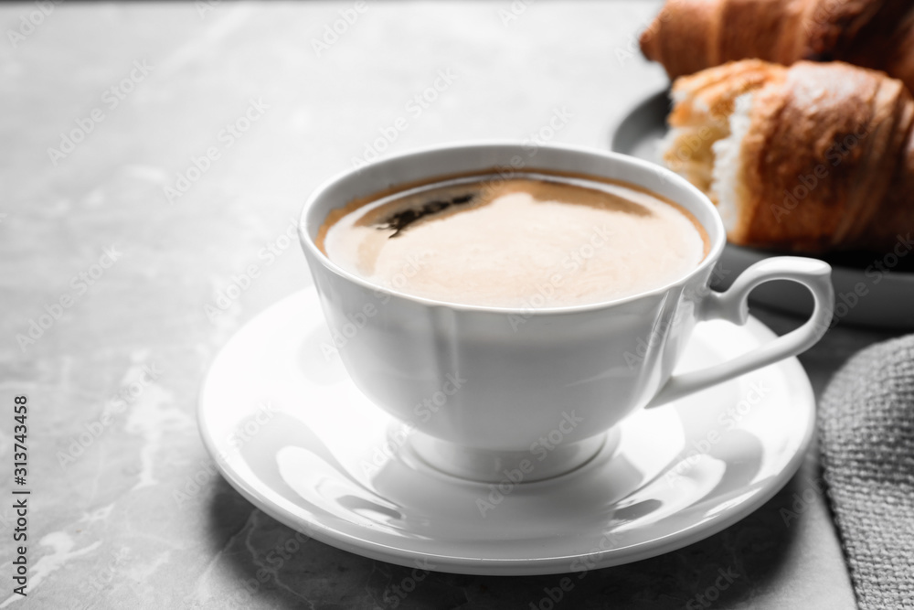 Coffee and tasty croissants on light grey marble table, closeup Coffee and tasty croissants on light grey marble table, closeup